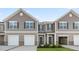 Newly constructed townhomes featuring gray siding, white trim, and attached garages at 276 Moyer Dr, Graham, NC 27253