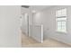 Bright hallway with neutral carpet, white walls and trim, and a window for natural light at 280 Moyer Dr, Graham, NC 27253