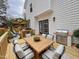 View of back porch with outdoor dining table and outdoor kitchen at 3 Azzi Ct, Durham, NC 27703