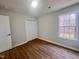 Bedroom features hardwood floors, a window letting in natural light, and a closet at 3 Azzi Ct, Durham, NC 27703