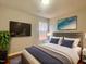 This modern bedroom boasts a comfortable bed, sleek TV, and stylish accents, creating a cozy retreat at 3 Azzi Ct, Durham, NC 27703