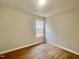 Bright bedroom features a window, wood-look flooring, neutral walls, and ample natural light at 3 Azzi Ct, Durham, NC 27703