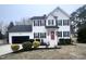 Beautiful two-story home with black shutters, a red door and a well manicured lawn at 3 Azzi Ct, Durham, NC 27703