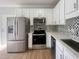 An updated kitchen featuring stainless steel appliances and granite countertops at 3 Azzi Ct, Durham, NC 27703