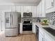 An updated kitchen featuring stainless steel appliances and granite countertops at 3 Azzi Ct, Durham, NC 27703