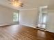 An open living room with neutral walls and flooring leading to entry and staircase at 3 Azzi Ct, Durham, NC 27703