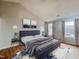 The main bedroom has a vaulted ceiling, and is furnished with stylish decor and soft, natural light at 3 Azzi Ct, Durham, NC 27703