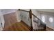 View of wood staircase with black metal balusters, leading to a white front door at 3 Azzi Ct, Durham, NC 27703