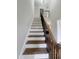 The elegant staircase features sleek, dark metal balusters and warm wood steps, blending style and functionality at 3 Azzi Ct, Durham, NC 27703