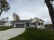 Beautiful one-story home with grey siding, a two-car garage, and a concrete driveway at 313 Lotus Ave, Smithfield, NC 27577