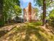 Spacious backyard featuring a wooden deck, fence, and mature trees at 3553 E Jameson Rd, Raleigh, NC 27604