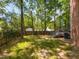Backyard featuring a wooden deck, brick exterior, and mature trees at 3553 E Jameson Rd, Raleigh, NC 27604