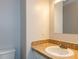 Simple powder room featuring tile countertop and basin sink at 3553 E Jameson Rd, Raleigh, NC 27604