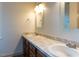 Bathroom with double sink vanity featuring a marble countertop and framed mirrors at 3553 E Jameson Rd, Raleigh, NC 27604