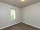 Bedroom featuring neutral walls, carpet and trim, with a view to the outside at 3553 E Jameson Rd, Raleigh, NC 27604