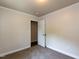 Bedroom with neutral walls, carpet and trim, and open closet with view to the outside at 3553 E Jameson Rd, Raleigh, NC 27604