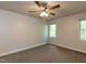 Neutral bedroom featuring ceiling fan and windows at 3553 E Jameson Rd, Raleigh, NC 27604