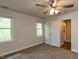 Sunlit bedroom with two windows and view to ensuite bathroom at 3553 E Jameson Rd, Raleigh, NC 27604