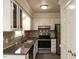 Well-lit kitchen featuring granite countertops and stainless steel appliances at 3553 E Jameson Rd, Raleigh, NC 27604