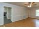 Spacious living room with hardwood floors and an opening leading into kitchen at 3553 E Jameson Rd, Raleigh, NC 27604