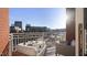 Condo balcony with seating and white railings offers skyline views on a sunny day at 400 W North St # 730, Raleigh, NC 27603
