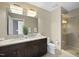 Bathroom with granite countertop, double vanity, and glass enclosed tiled shower at 400 W North St # 730, Raleigh, NC 27603