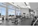 Community gym featuring treadmills, weights, machines and ample natural light at 400 W North St # 730, Raleigh, NC 27603