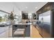 Well-appointed kitchen with granite countertops, modern cabinetry, stainless steel appliances, and breakfast bar seating at 400 W North St # 730, Raleigh, NC 27603