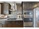 Close-up of kitchen showcasing stainless steel appliances, dark cabinets, and modern backsplash at 400 W North St # 730, Raleigh, NC 27603