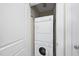 Stacked washer and dryer in a closet with a white door and silver hardware at 400 W North St # 730, Raleigh, NC 27603