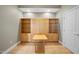 Cozy living area with light-colored walls, hardwood floors, and a large built-in shelving unit with a table at 400 W North St # 730, Raleigh, NC 27603