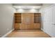 Cozy living area with light-colored walls, hardwood floors, and a large built-in shelving unit with a table at 400 W North St # 730, Raleigh, NC 27603