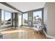 Bright living area with hardwood floors, large windows offering city views, and stylish egg chair at 400 W North St # 730, Raleigh, NC 27603