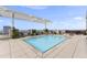 Rooftop pool with lounge chairs, patio tables and chairs and overhead awning at 400 W North St # 730, Raleigh, NC 27603