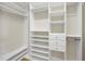 Walk-in closet with custom shelving, drawers, and hanging rods for optimal organization at 400 W North St # 730, Raleigh, NC 27603