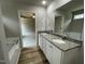 Bright bathroom features a granite countertop, dual sinks and white cabinetry at 416 Magnolia Run Way, Benson, NC 27504