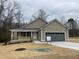 Charming single-story home featuring neutral siding, a welcoming front porch, and an attached two-car garage at 416 Magnolia Run Way, Benson, NC 27504