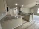 Bright kitchen with granite countertops, stainless steel appliances, and wood-look floors, open to living area at 416 Magnolia Run Way, Benson, NC 27504