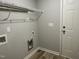 Neutral laundry room with shelving and connections at 416 Magnolia Run Way, Benson, NC 27504