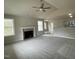 Spacious living room with a fireplace, a ceiling fan, and plenty of natural light from the windows at 416 Magnolia Run Way, Benson, NC 27504