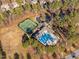 Aerial view of community amenities including pool, tennis courts, and clubhouse surrounded by trees and landscaping at 43 New Rhododendron, Chapel Hill, NC 27517