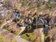 An aerial view of a beautiful home in a wooded neighborhood with a circular driveway at 43 New Rhododendron, Chapel Hill, NC 27517