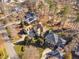 An aerial view captures a home with mature landscaping and neighboring properties at 43 New Rhododendron, Chapel Hill, NC 27517