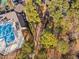 Aerial view showcasing a community pool, playground, and wooded common areas at 43 New Rhododendron, Chapel Hill, NC 27517
