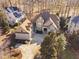 Aerial view of a home with a sprawling driveway and lush, mature trees at 43 New Rhododendron, Chapel Hill, NC 27517