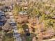 Aerial view of a neighborhood with a pond featuring a fountain near a road at 43 New Rhododendron, Chapel Hill, NC 27517