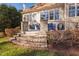 Relaxing back patio with stone steps, blue Adirondack chairs, and decorative plants at 43 New Rhododendron, Chapel Hill, NC 27517