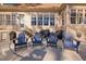Spacious back patio with four Adirondack chairs and outdoor cooking appliances at 43 New Rhododendron, Chapel Hill, NC 27517