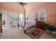 Bedroom with a four-poster bed, ceiling fan, and large windows at 43 New Rhododendron, Chapel Hill, NC 27517
