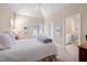 Bright bedroom with an ensuite bathroom, featuring a large window and vaulted ceiling at 43 New Rhododendron, Chapel Hill, NC 27517